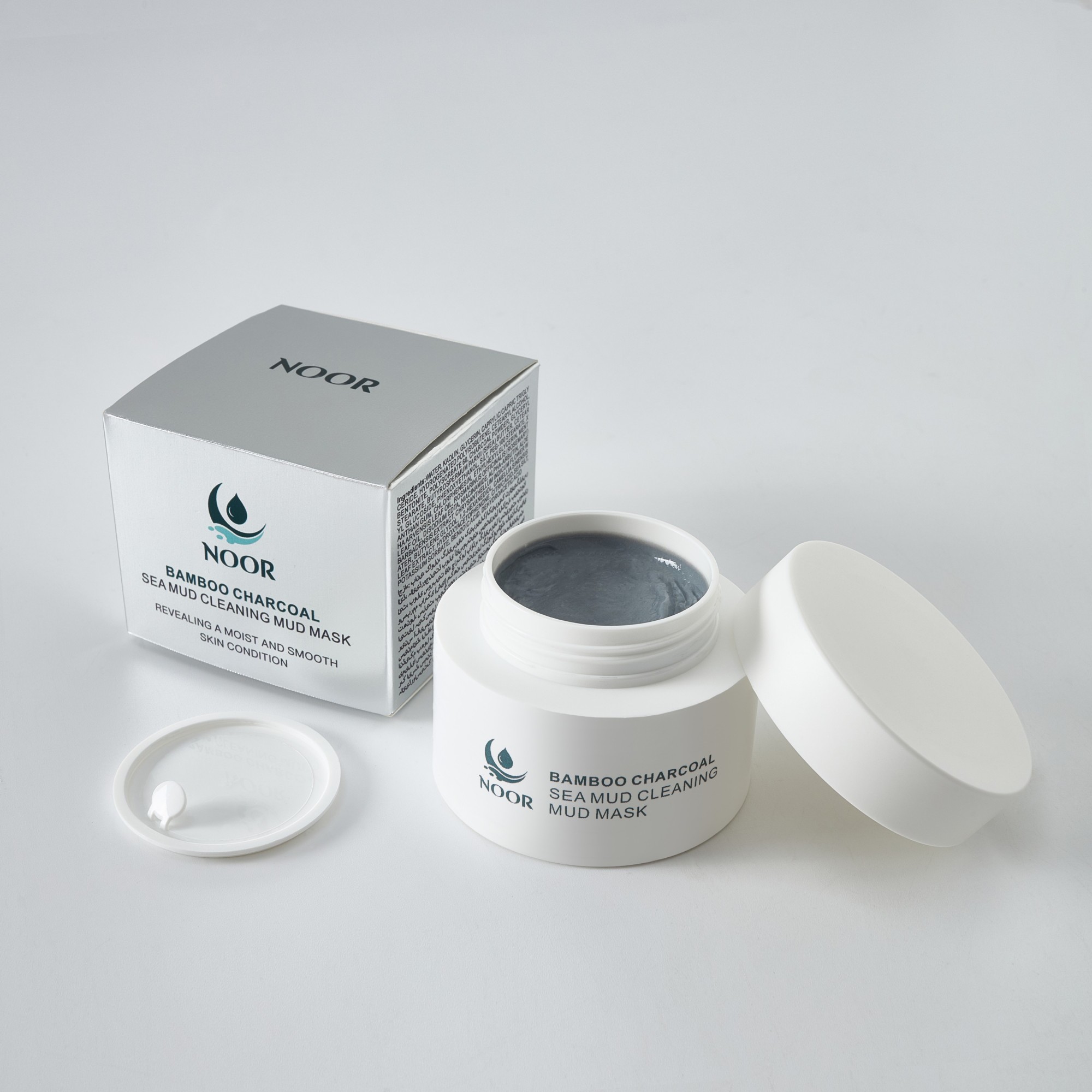 NOOR bamboo charcoal sea mud mask open beside its silver box